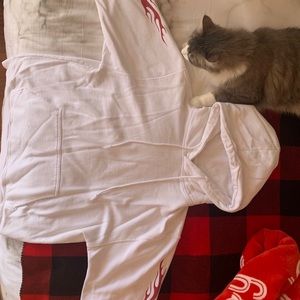 White hoodie with red flames on sleeves
